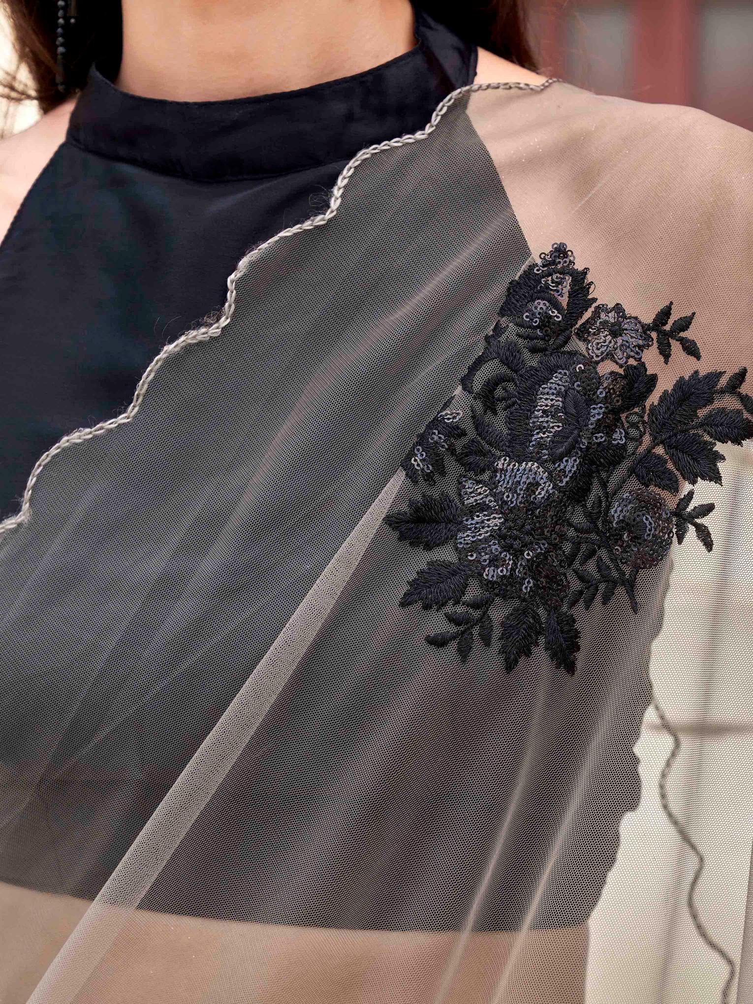 Tan colored embroidered net saree with scalloped border